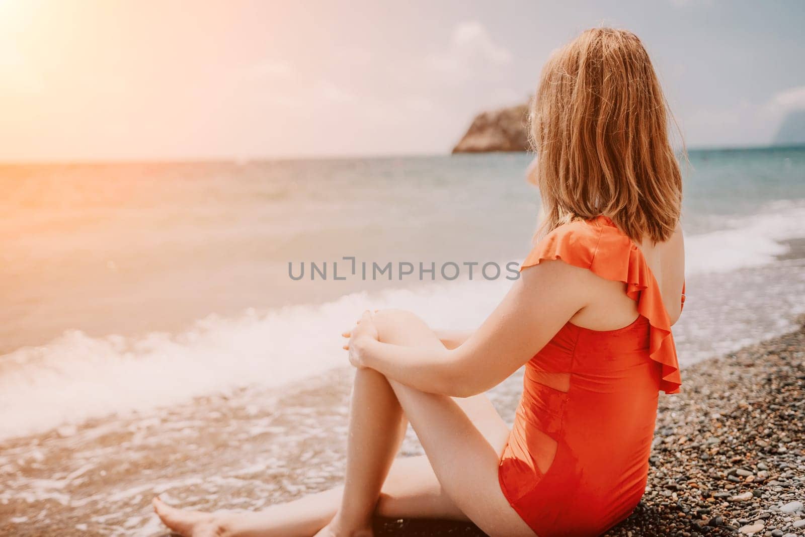 Happy loving family mother and daughter having fun together on the beach. Mum playing with her kid in holiday vacation next to the ocean - Family lifestyle and love concept.