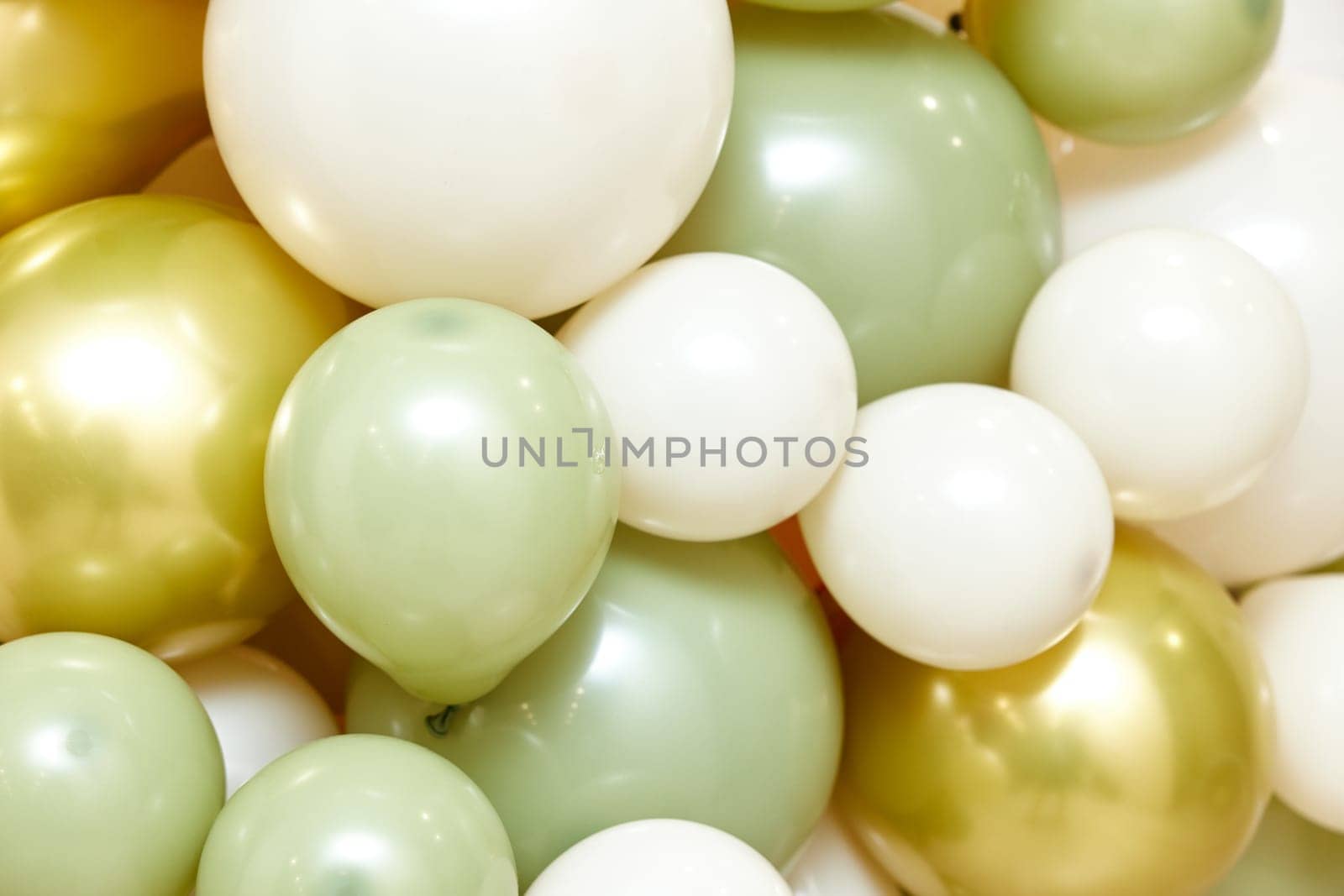 Many white green and gold balloons as background