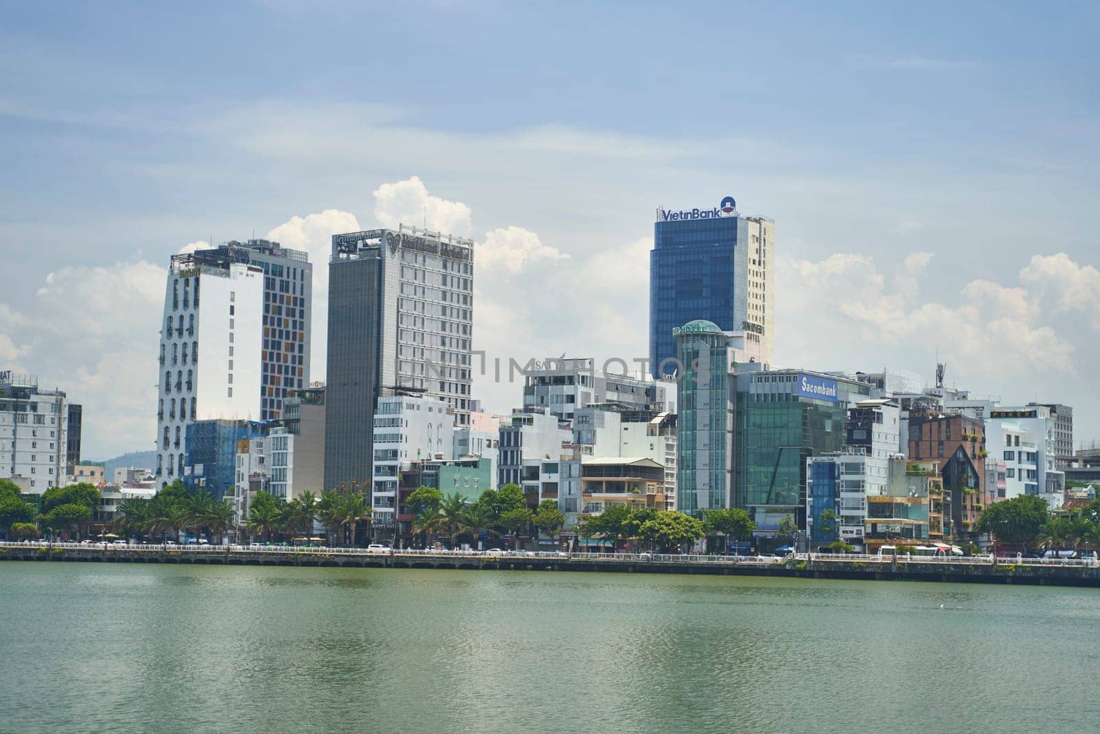 Danang, Vietnam - 06.27.2023: View of skyscrapers across the Han River in Da Nang city, Vietnam. High quality photo