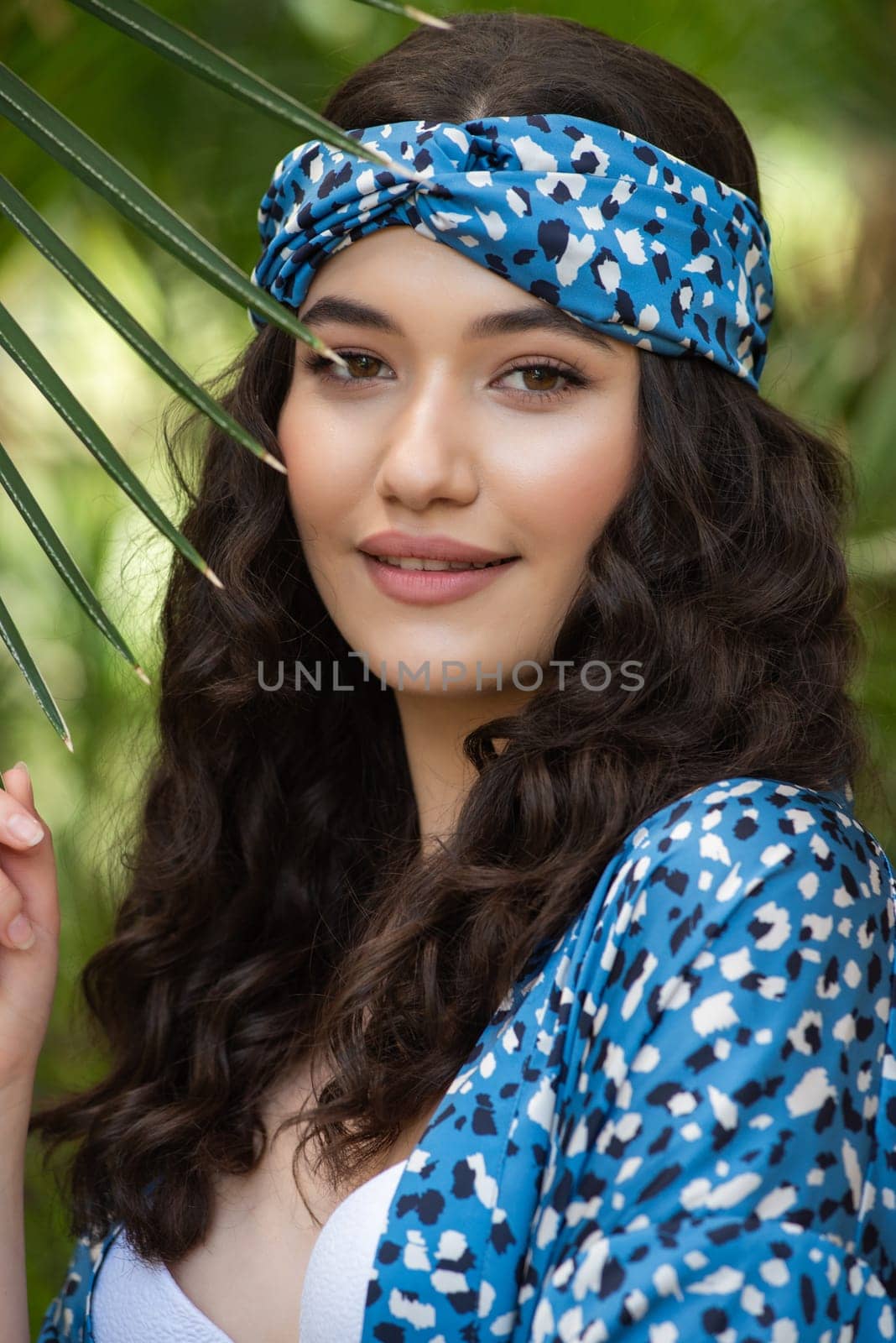 Beautiful young woman wearing summer clothes on tropical resort by OleksandrLipko