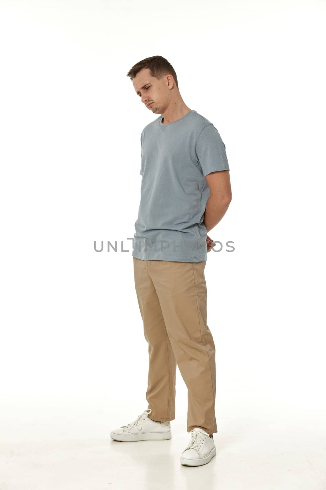 offended frustrated young man on white background. sadness