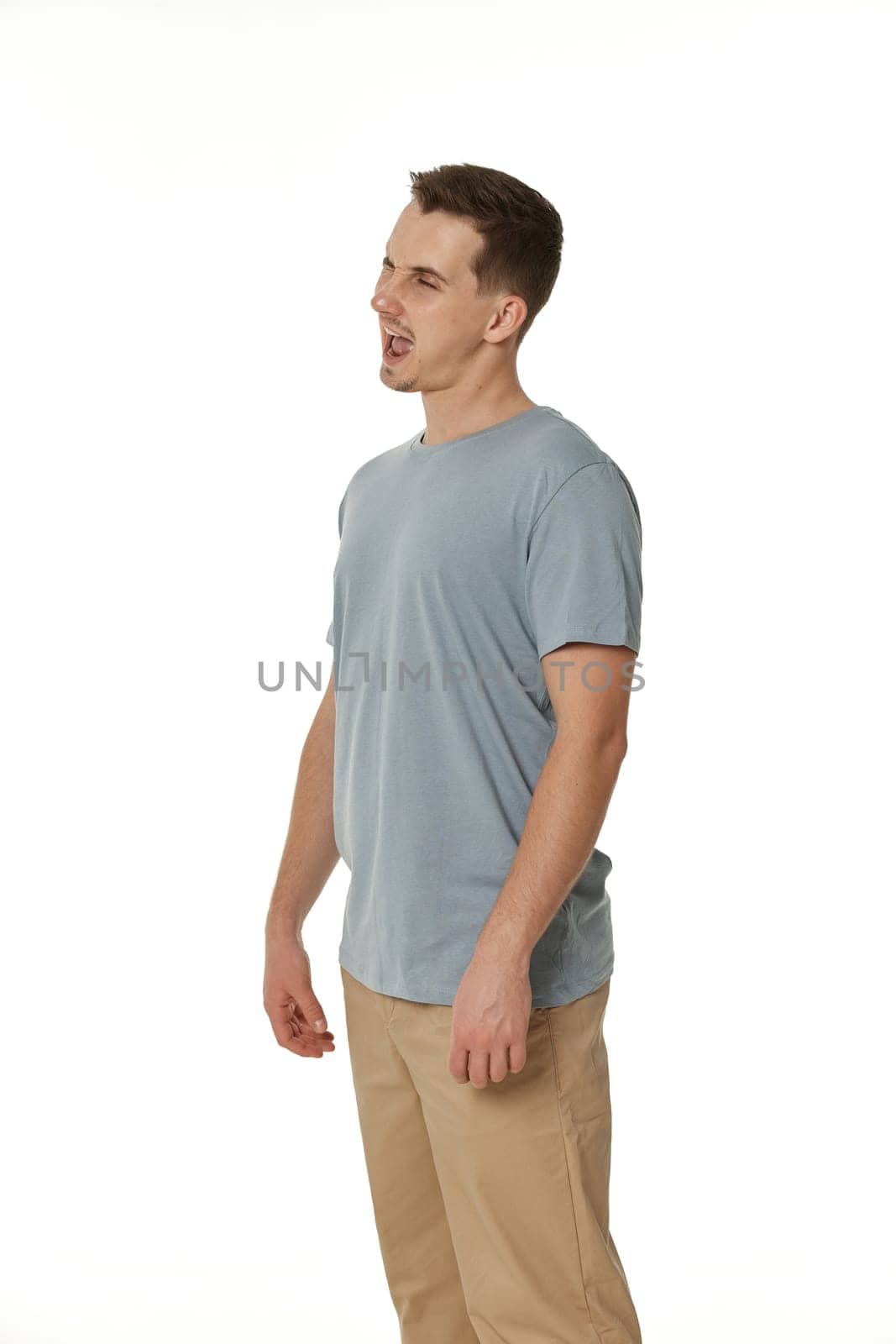 portrait of young happy man winking looking at the camera on white background