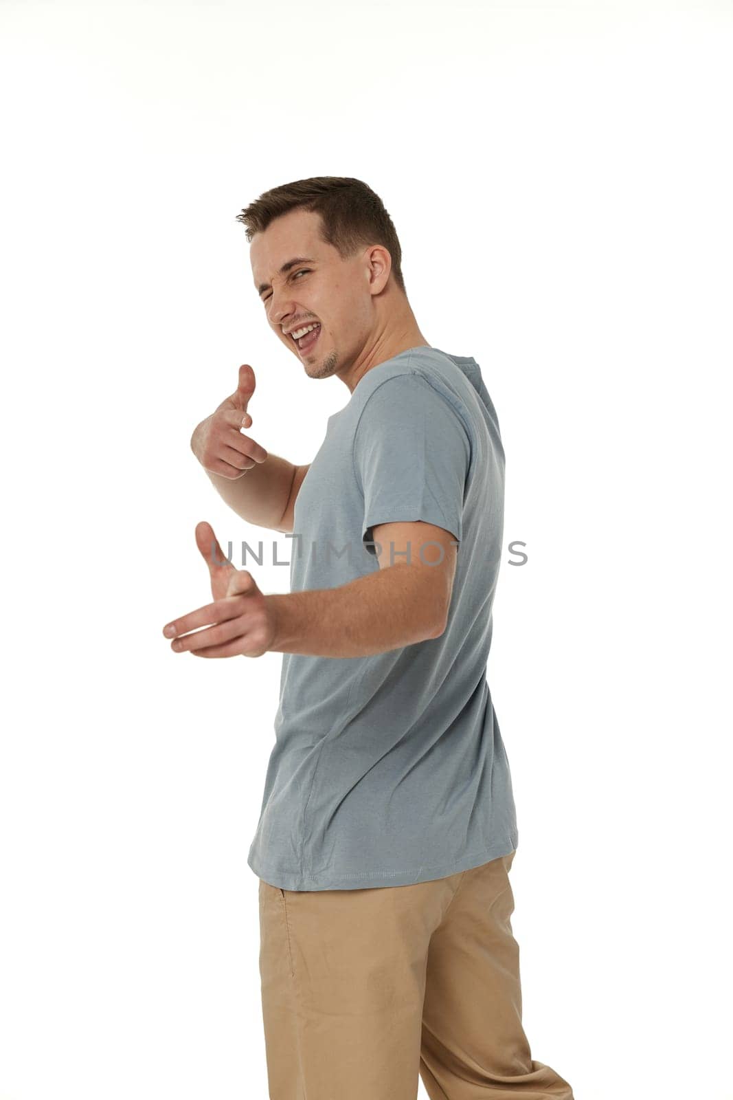 happy guy pointing at you on white studio background