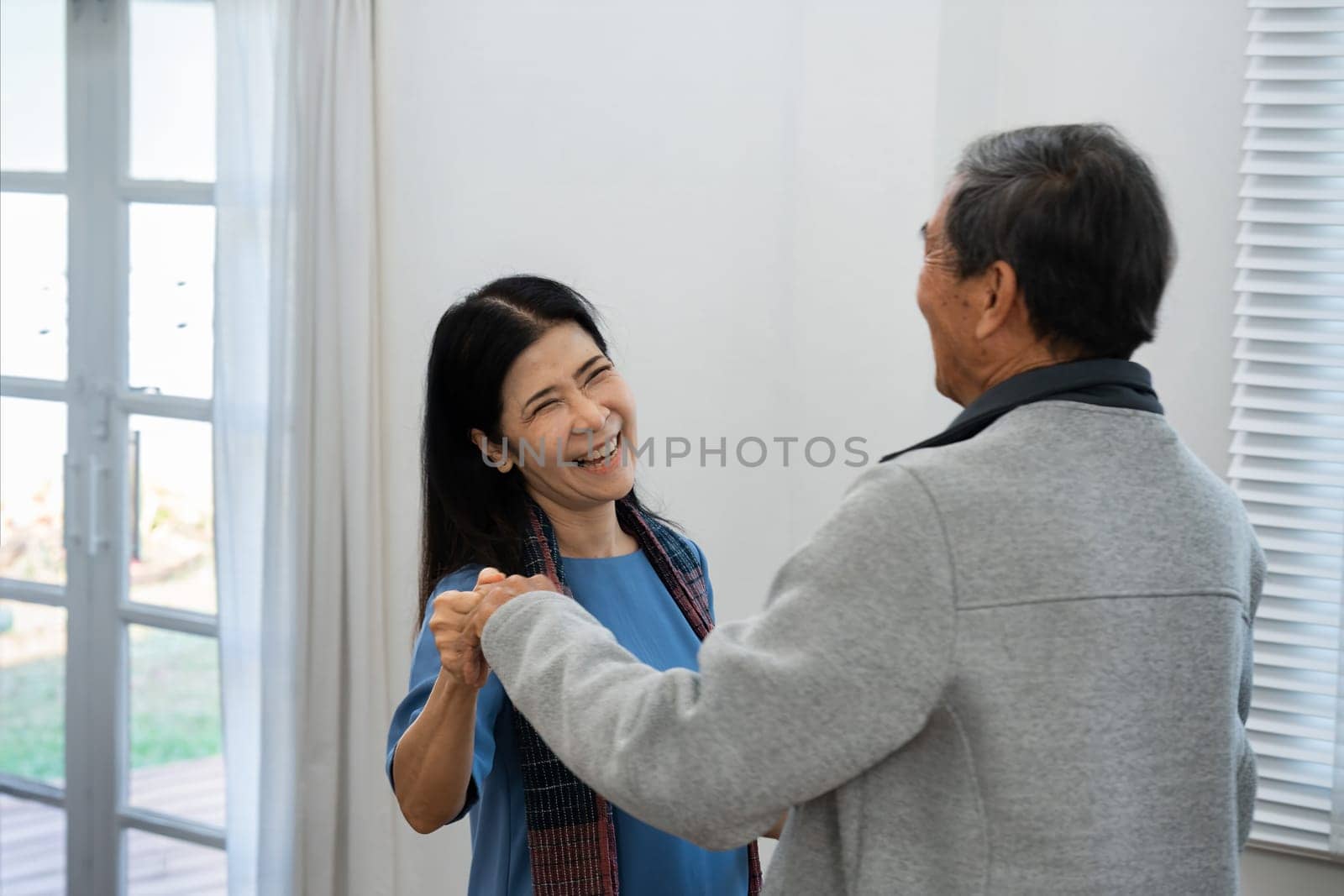 Holding hands, hug or happy old couple dancing for love, support or trust in marriage at home together.