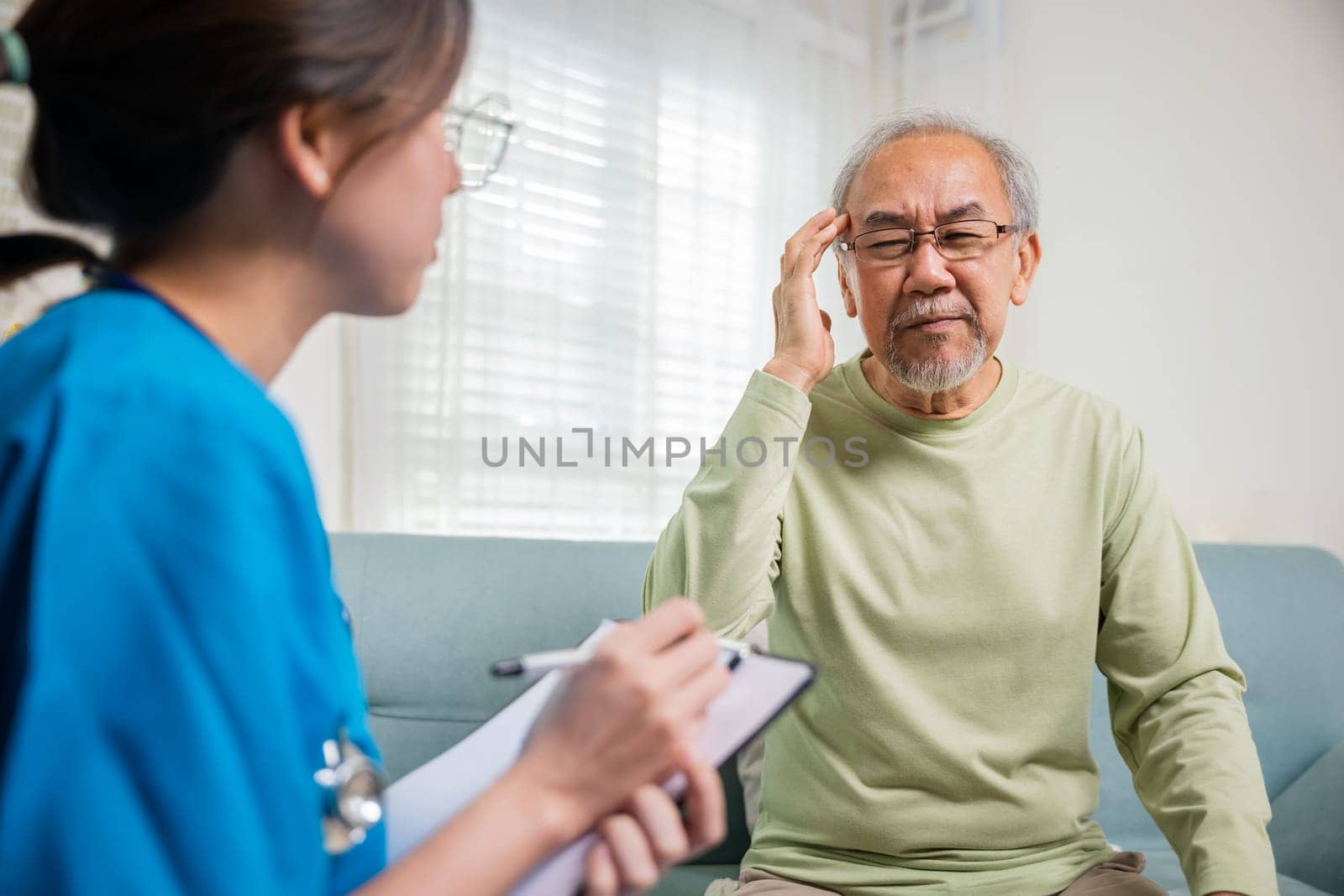 Asian senior old man patient have headache and woman nurse talking by Sorapop