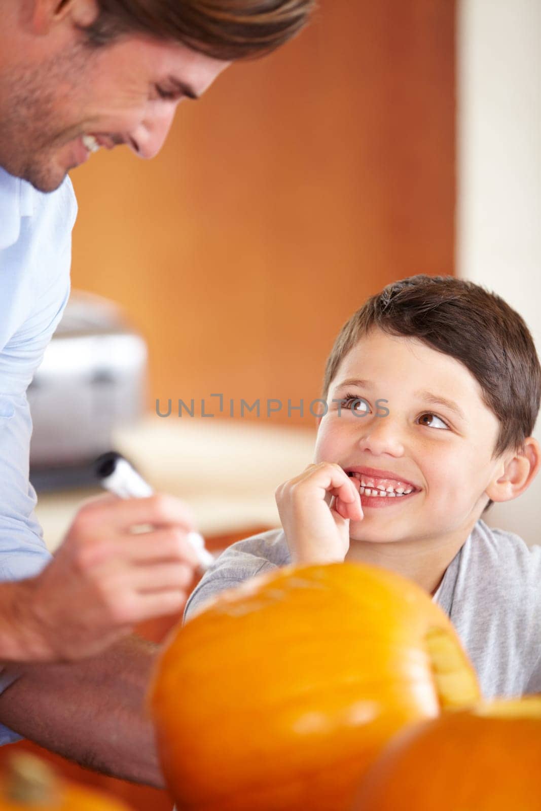 Halloween, pumpkin and father with kid in the kitchen for holiday celebration at home. Creative, smile and happy dad with boy child bonding and carving vegetable for decoration or tradition at house. by YuriArcurs