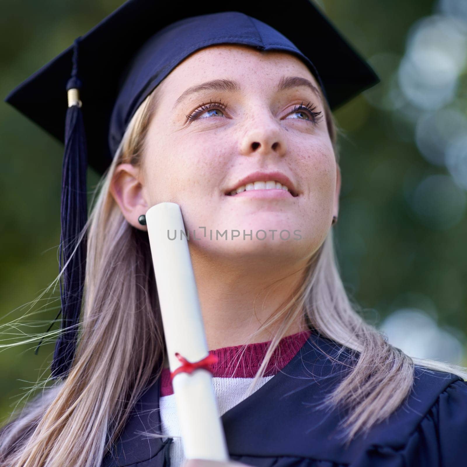Happy woman, student and certificate in graduation for qualification, education or career ambition. Face of female person or graduate smile in diploma, degree or award with vision at outdoor ceremony.