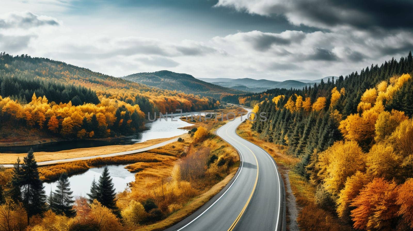 Scenic aerial view of a road passing through the colorful forest at fall. High quality photo