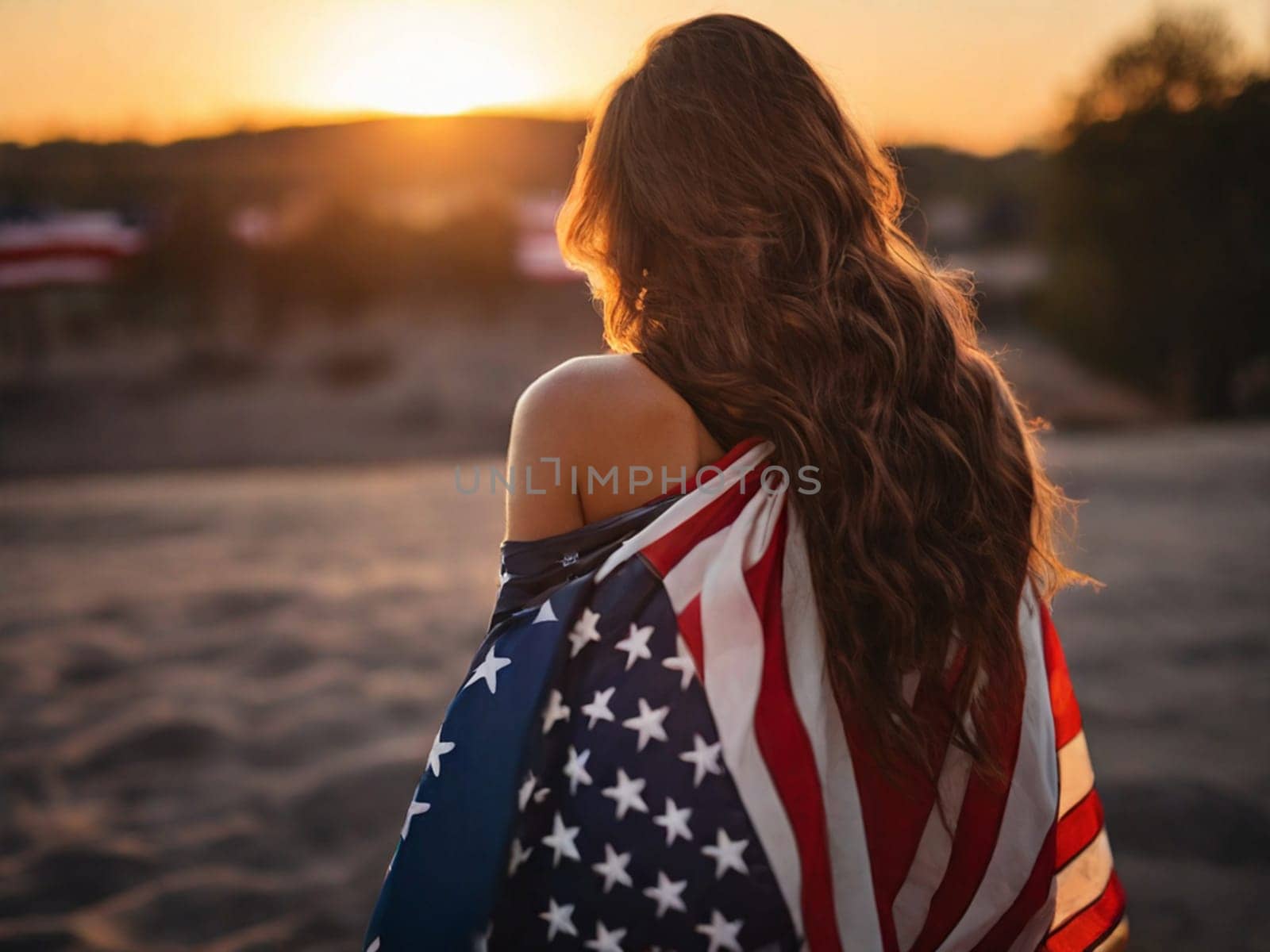 Rear view of a young woman with long hair with a USA flag on her shoulders enjoying the sunset in nature by Ekaterina34
