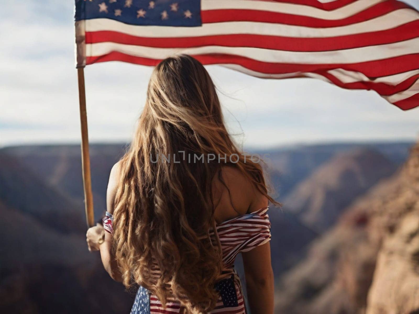 Rear view of young woman with long hair holding USA flag enjoying sunset in nature.