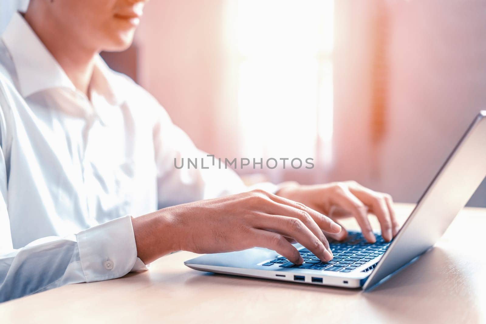 Businessman hand typing on computer keyboard of a laptop computer in office. Business and finance concept. uds