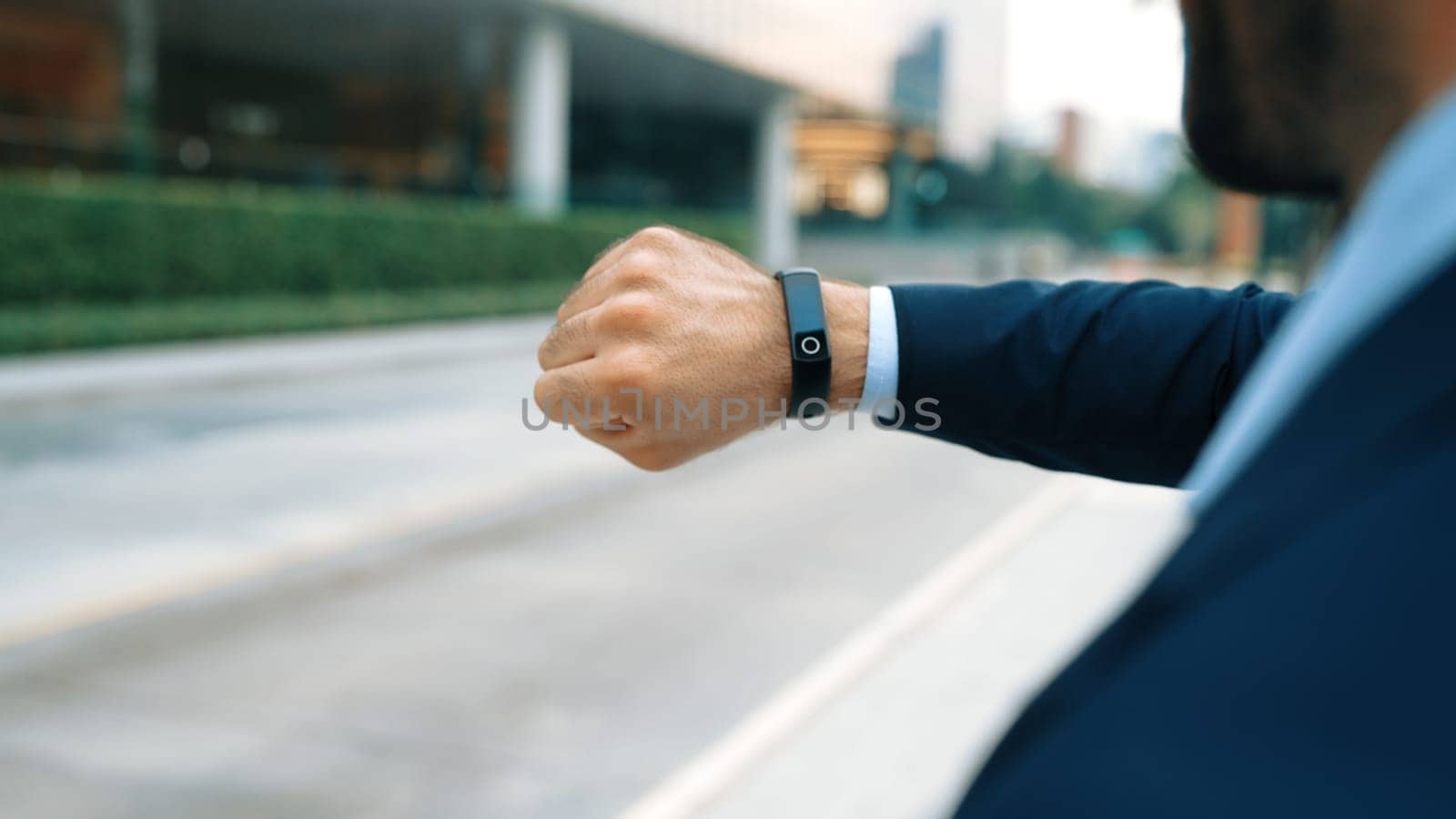 Closeup of professional businessman hand show smart watch and pointing the times. Professional boss, ceo, leader checking time from top view with city view. Business. Blurred background. Exultant.