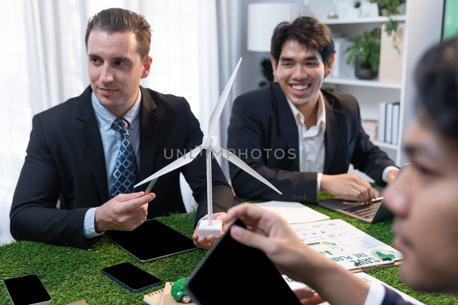 Diverse group of business people planning for alternative energy utilization for greener sustainable Earth by reducing CO2 emission and carbon credit with renewable clean energy technology. Quaint