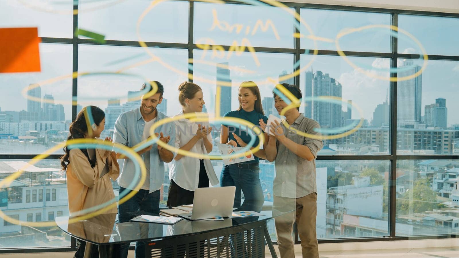 Business team clapping hand together at idea written on glass wall. Tracery by biancoblue