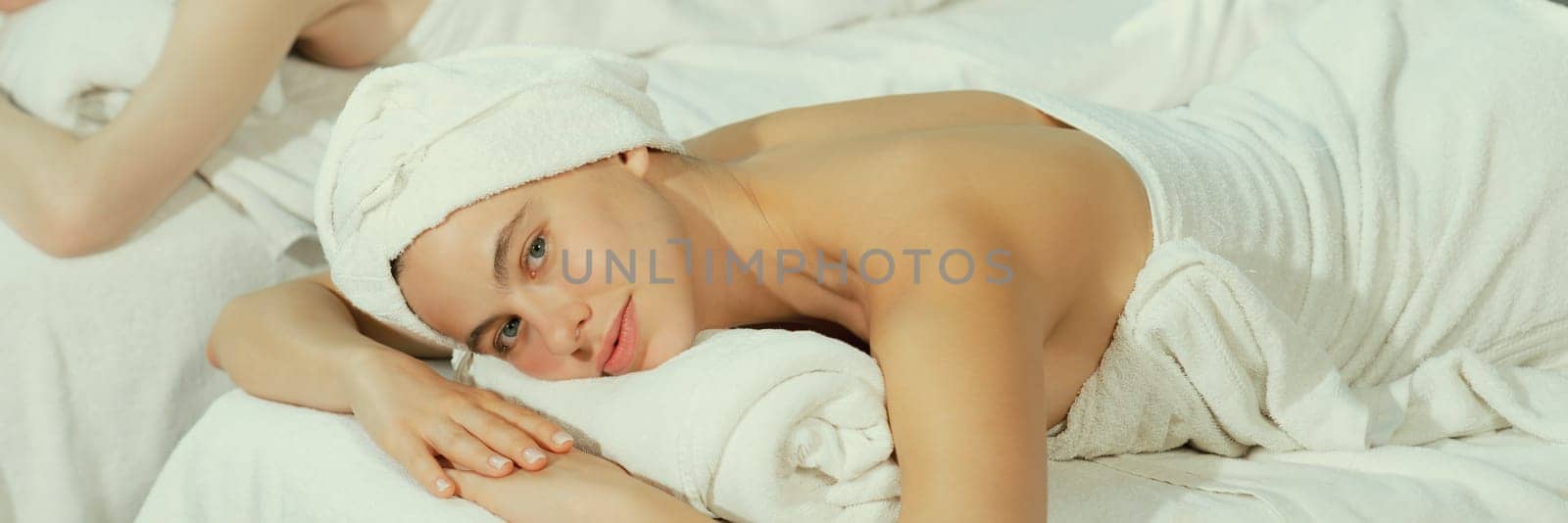 Pretty girl relaxes on a spa bed while looking at camera. Close up. Tranquility by biancoblue