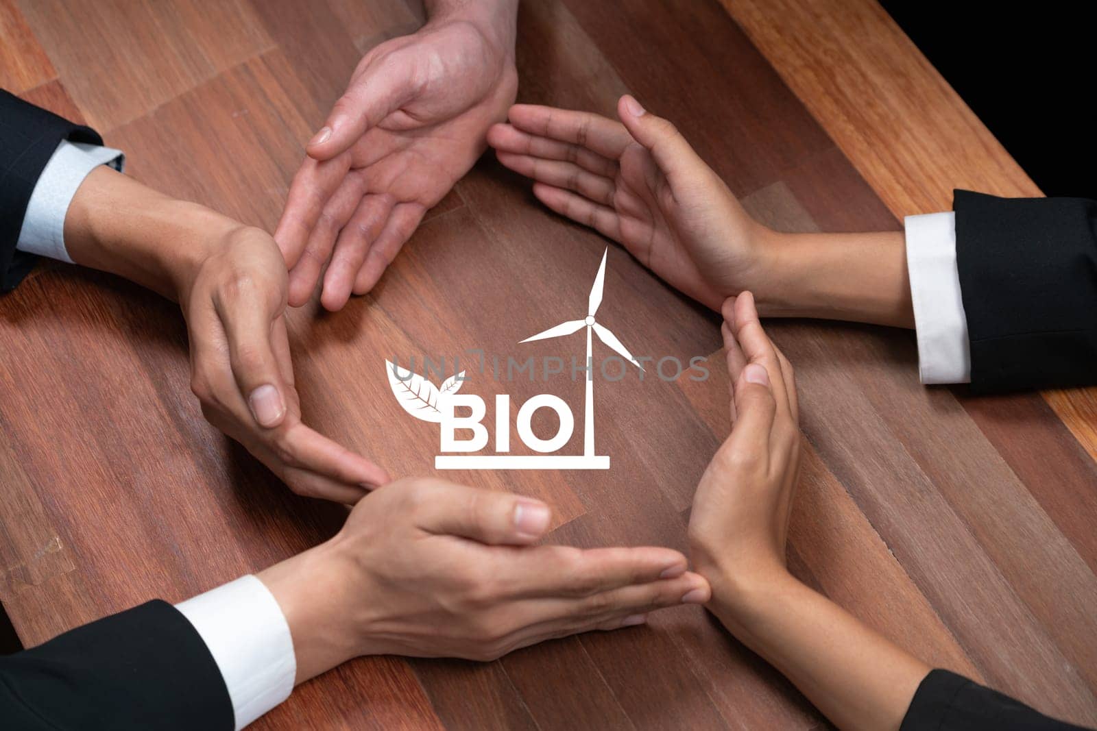 Top view group of business people forming circle hand together around eco-friendly bio fuel icon on meeting table. Alternative energy with Bio technology for greener and sustainable future. Quaint