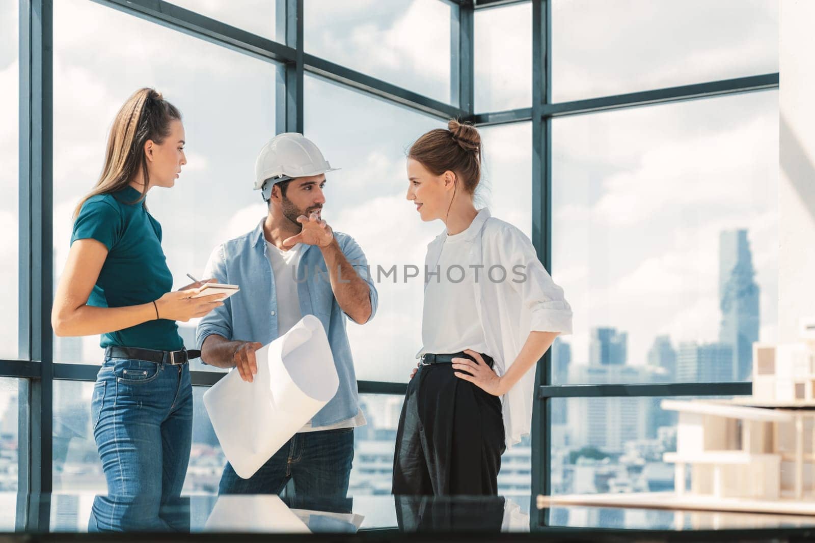 Group of architect engineer looking at project plan while brainstorming idea about building structure. Manager team discuss about building construction while standing near with city view. Tracery.