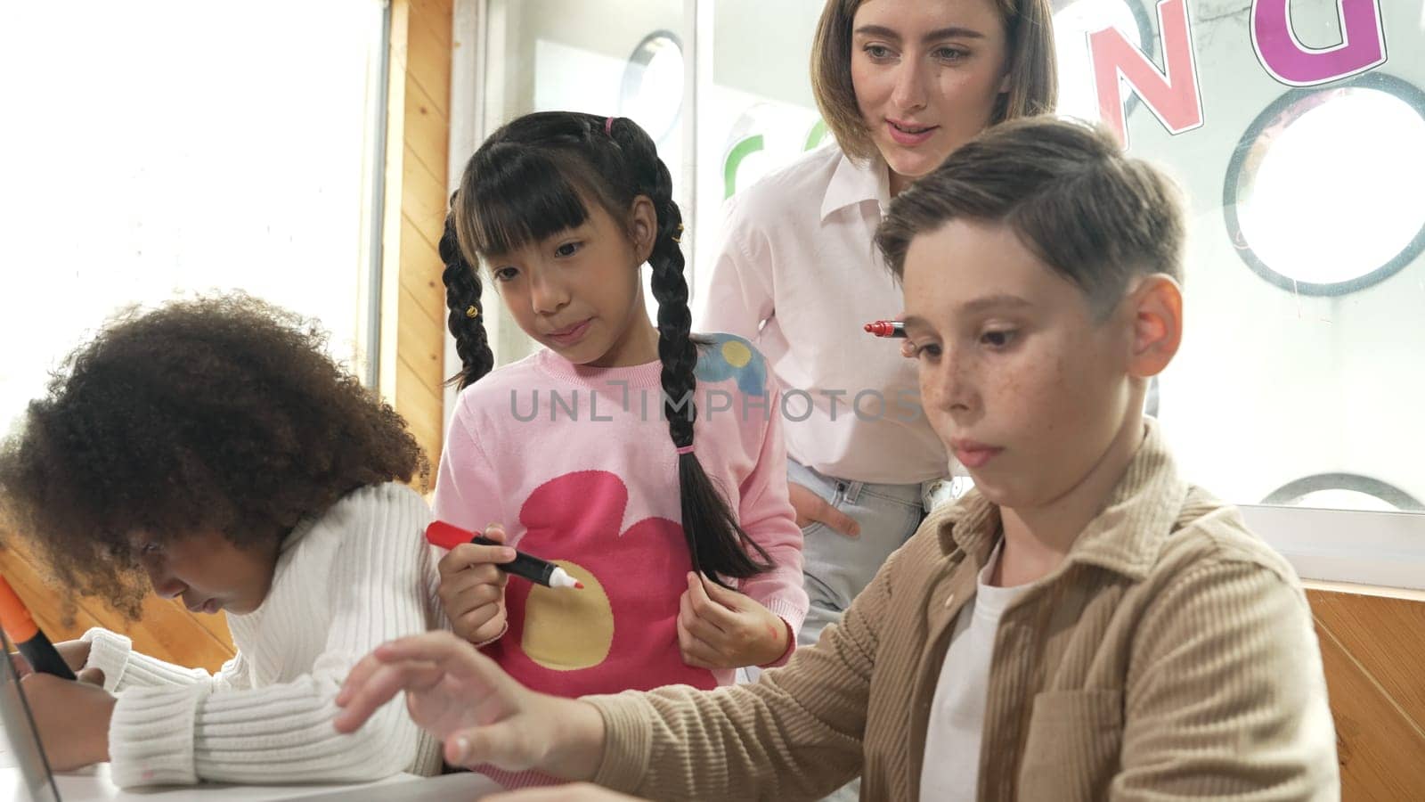 Smart teacher teaching and looking student using laptop at classroom. Professional instructor explained about programing engineering code or prompt while studying and learning program. Erudition.