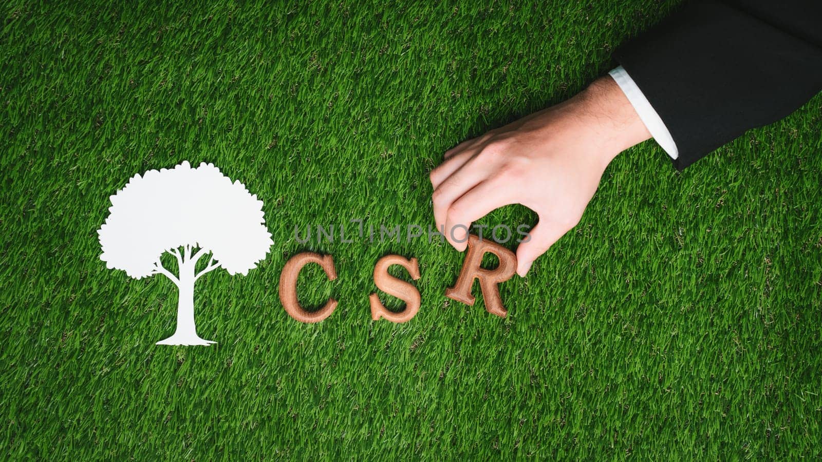 Hand arrange wooden alphabet text in CSR on biophilic background. Gyre by biancoblue