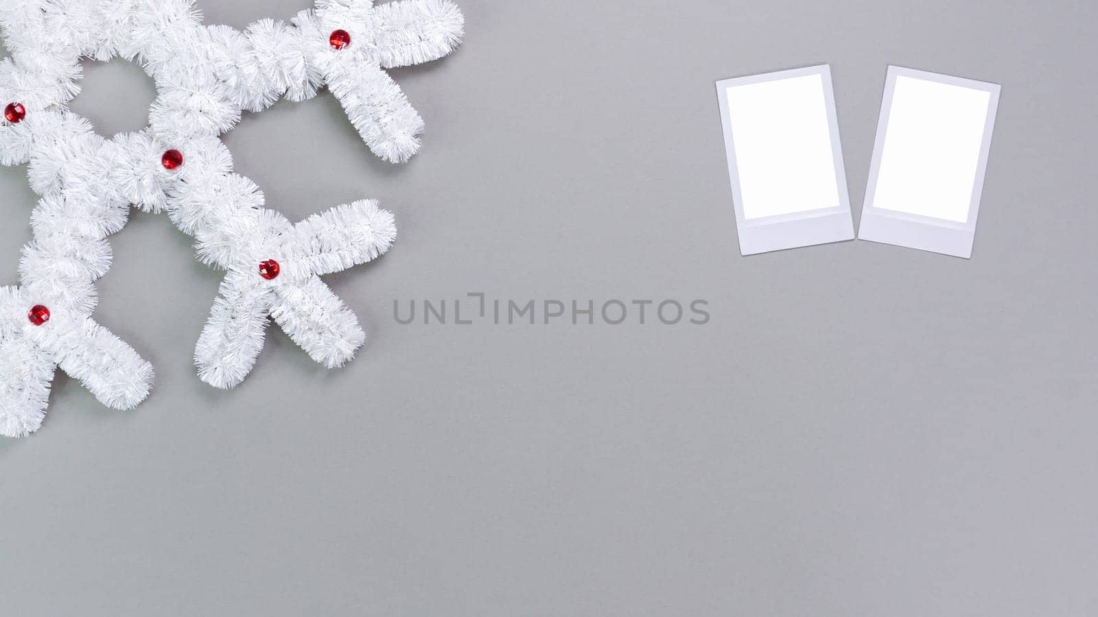 Retro photo frames isolated on grey background. Real photo template. Two frames. Mockup. Christmas white fluffy snowflake. Winter decoration