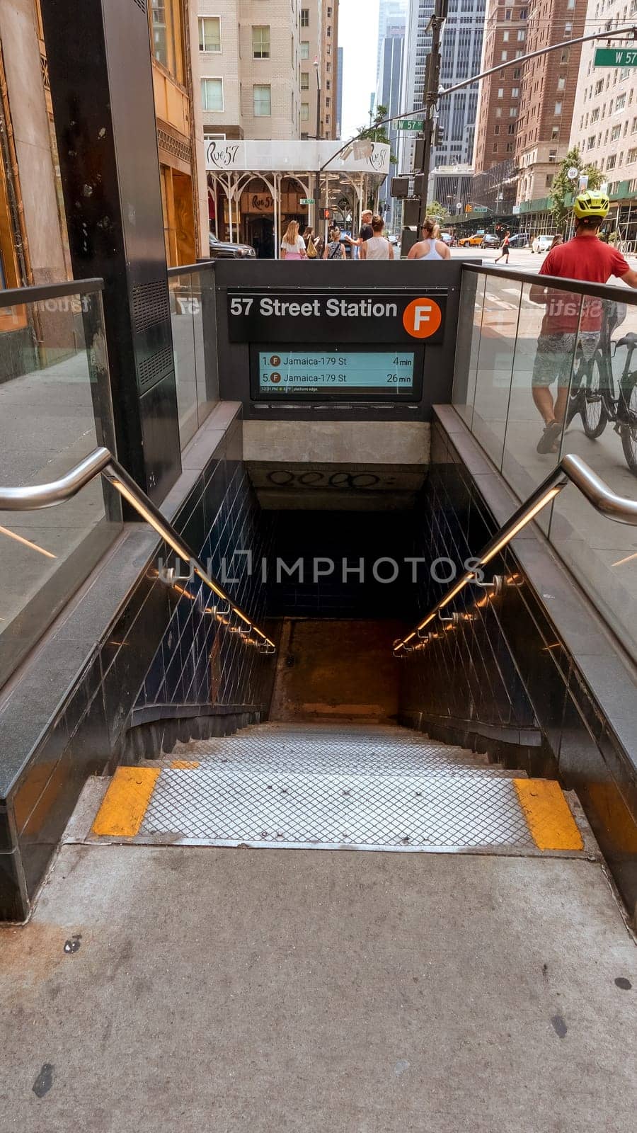 Entrance and stairs down to subway station in New York. New York City Subway is one of the world's oldest public transit systems. New York, USA - July 15, 2023 by JuliaDorian