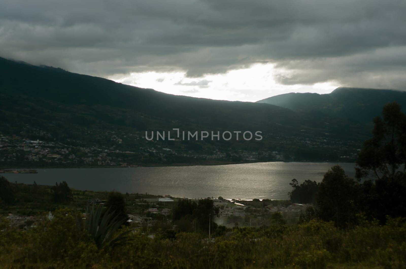 This photo captures the stunning sight of Lake San Pablo with the majestic Andes Mountains in the background in Ecuador.