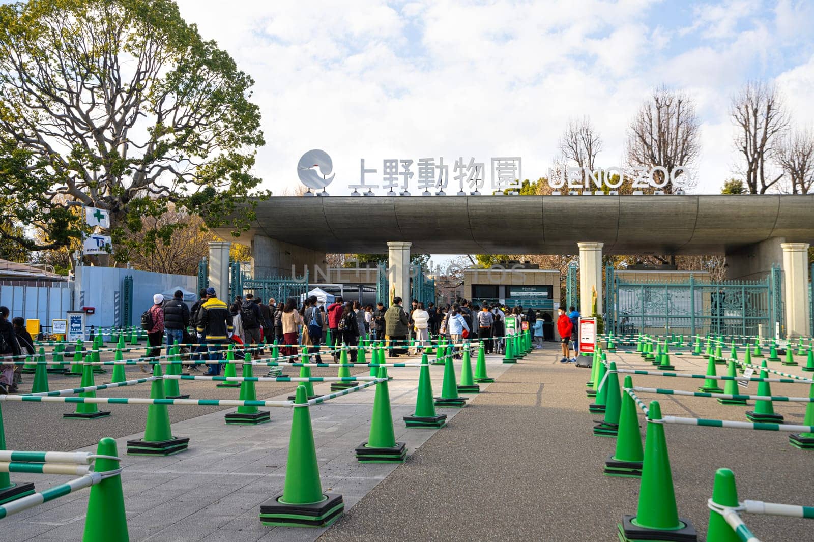 Tokyio, Japan. January 2024.  A crowd of visitors waiting in front of the entrance to the Ueno Zoo in Ueno Park, in the city centre