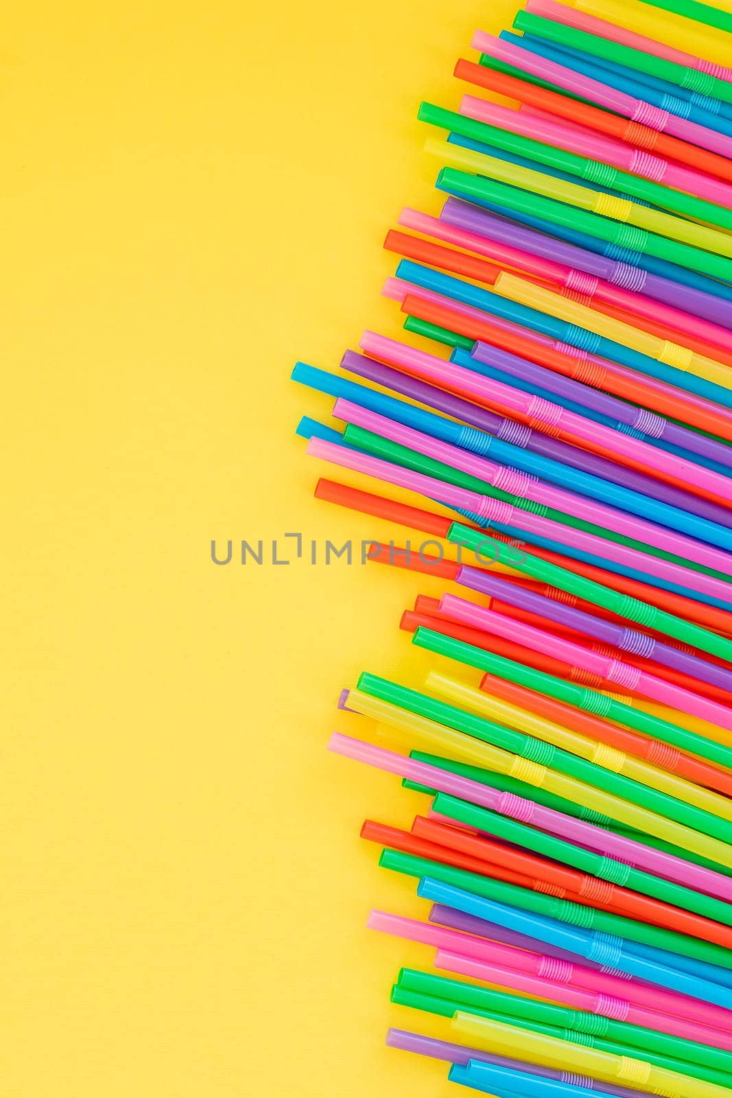 frame with Multi Color flexible straws.Plastic straws and earth globe, world pollution concept. plan to ban the sale of plastic straws to help reduce pollution. Drinking straw for party.Copy space by YuliaYaspe1979