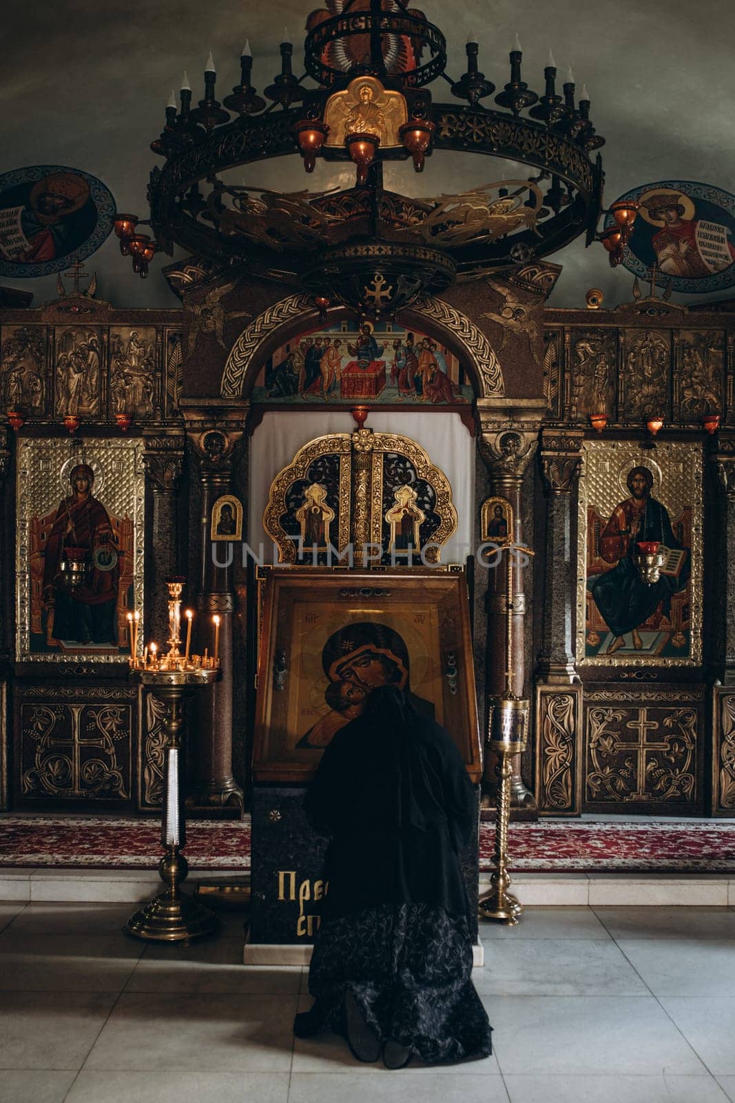 monk kneeling in front of the church icon. High quality photo