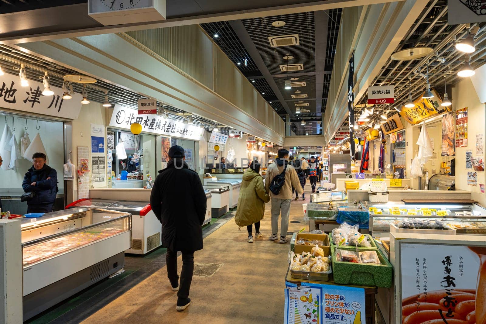 Tokyio, Japan. January 2024. People among stalls selling fresh fish at the Tsukiji Outer Market in the city centre