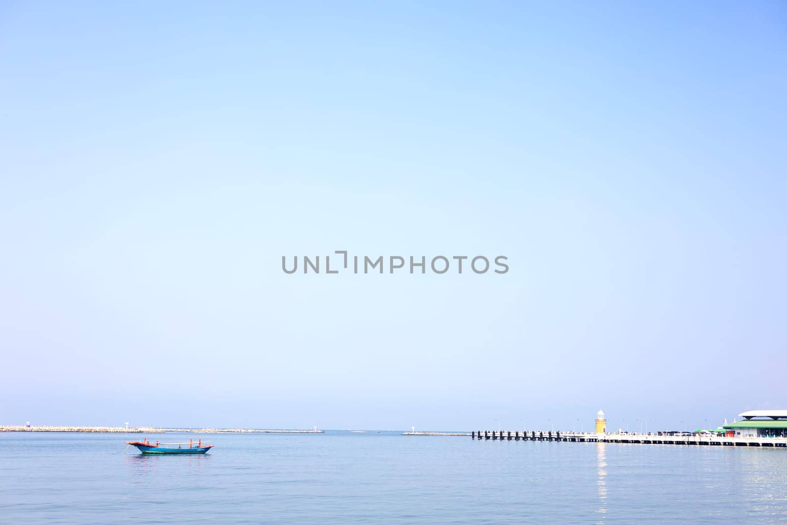 Lighthouse And Fishing Boat Over The Calm Sea. Background.