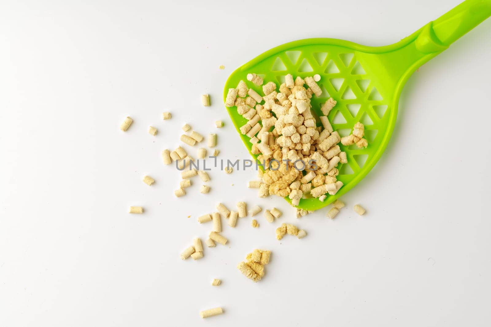 Wooden pet litter filler with scoop isolated on white background close up