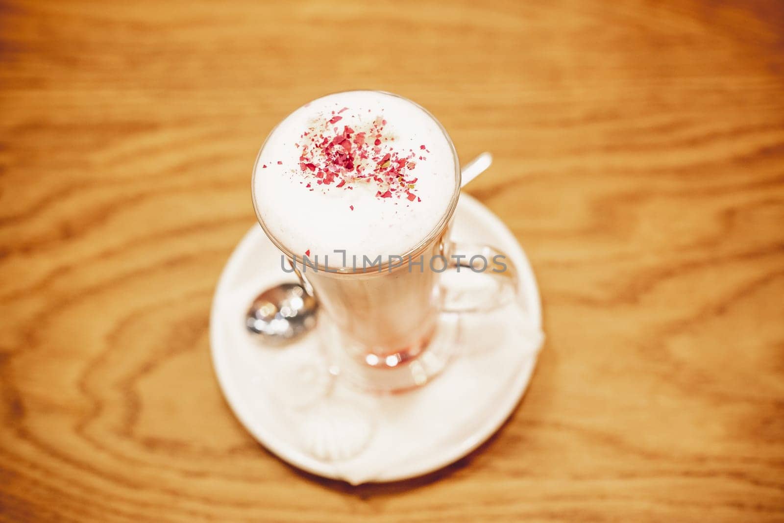 Frothy, layered cappuccino in clear glass mug with cinnamon sprinkled on top.Coffee time, delicious sweet drink.Fresh Energy Aromatic Barista Morning Breakfast Drink.Latte Macchiato with Cocoa Powder by YuliaYaspe1979