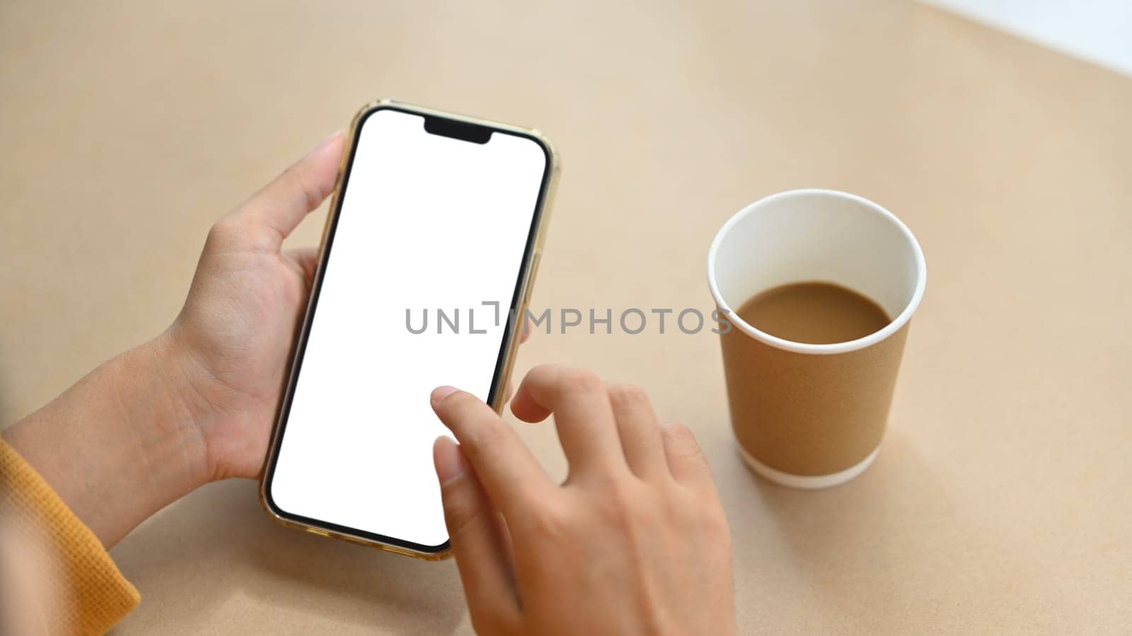 Woman hands holding mobile phone with blank screen for advertising text message. Closeup view.