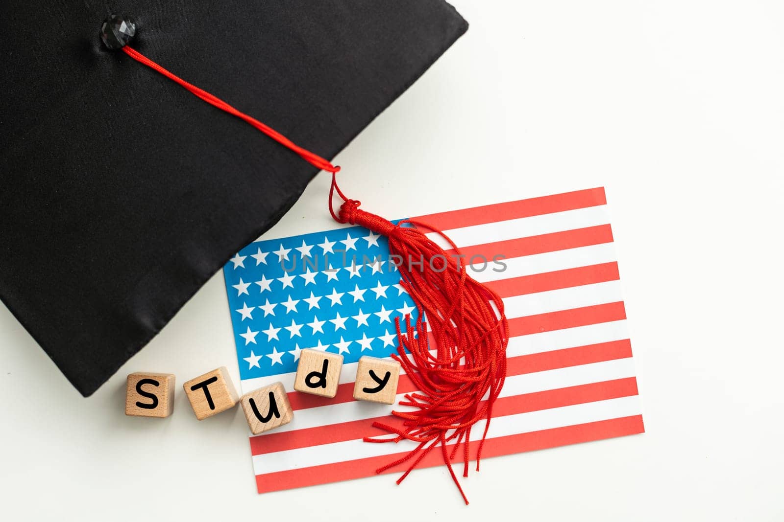 graduation hat on US flag, education concept by Andelov13