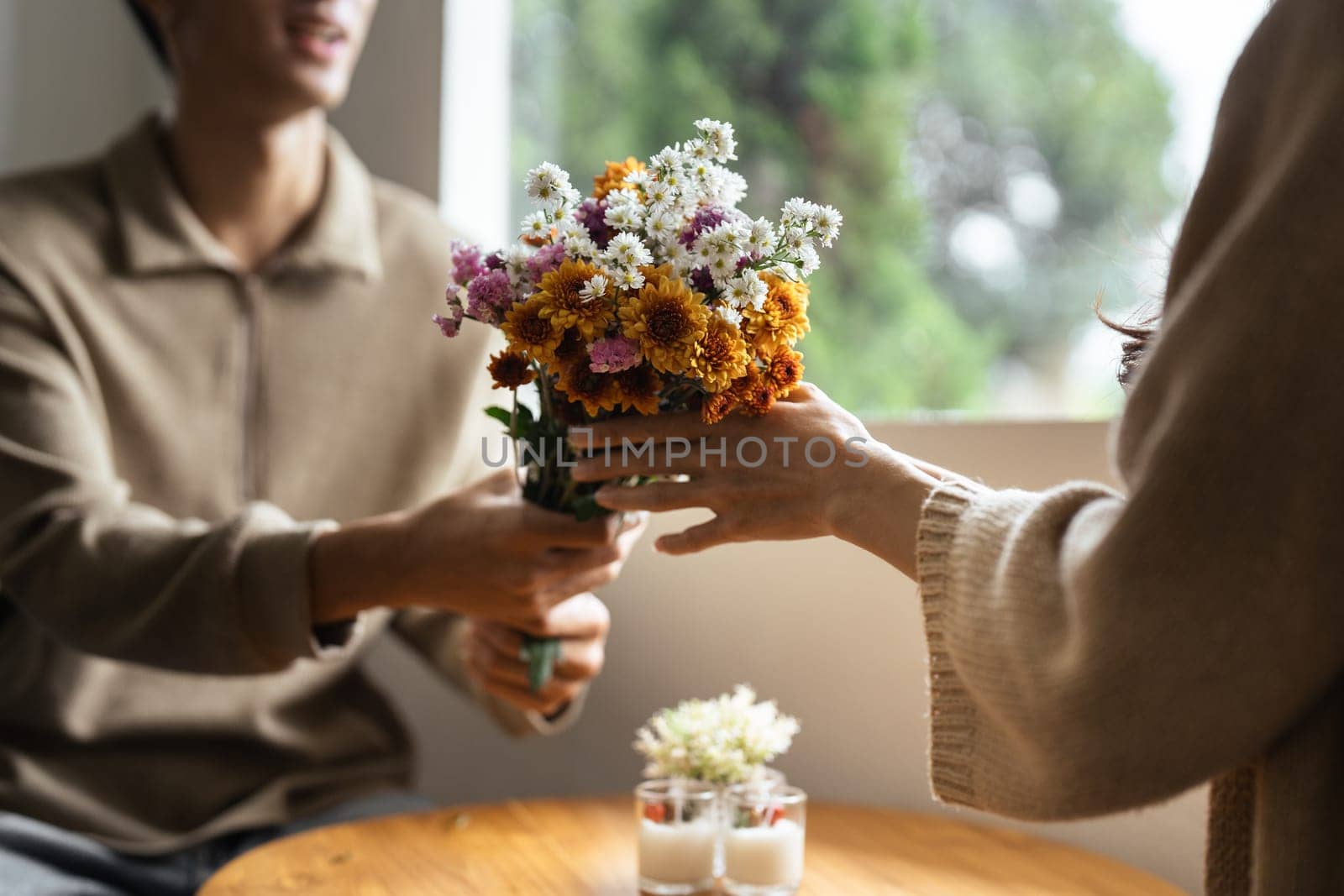 Young couple Hug and giving flower on Valentine's Day. Romantic day together. Valentine's Day concept.