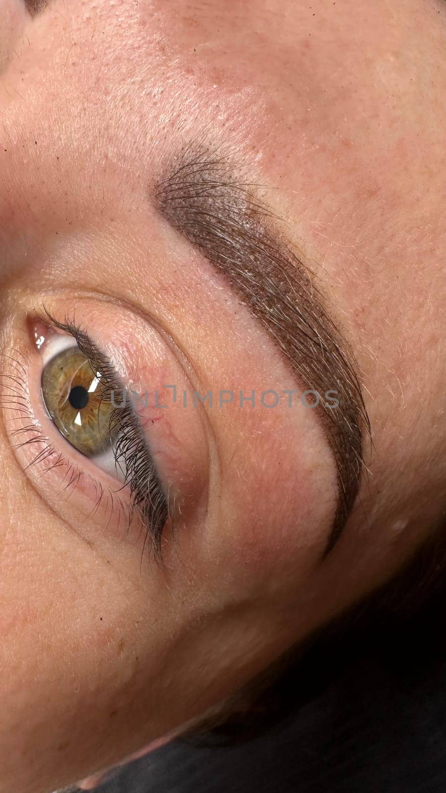 Close up view of beautiful brown female eye. Perfect trendy eyebrow. Good vision, contact lenses, brow bar or fashion eyebrow makeup concept by SmirMaxStock