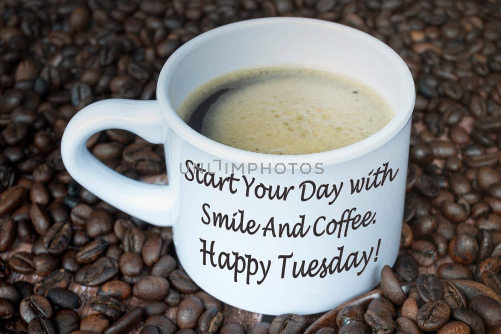 Motivational quote on a cup of coffee with beans background - Start your day with smile and coffee. Happy tuesday.