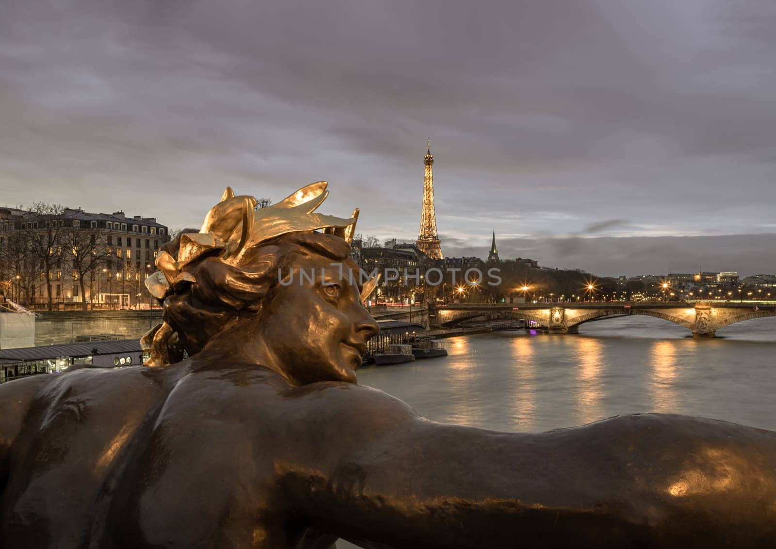 France, Paris - Jan 4, 2024 - Nice scenery of Golden statue adorning Pont Alexandre III Bridge over the Seine River and Eiffel Tower in Paris at sunset. Destinations in Europe. Space for text, Selective focus.