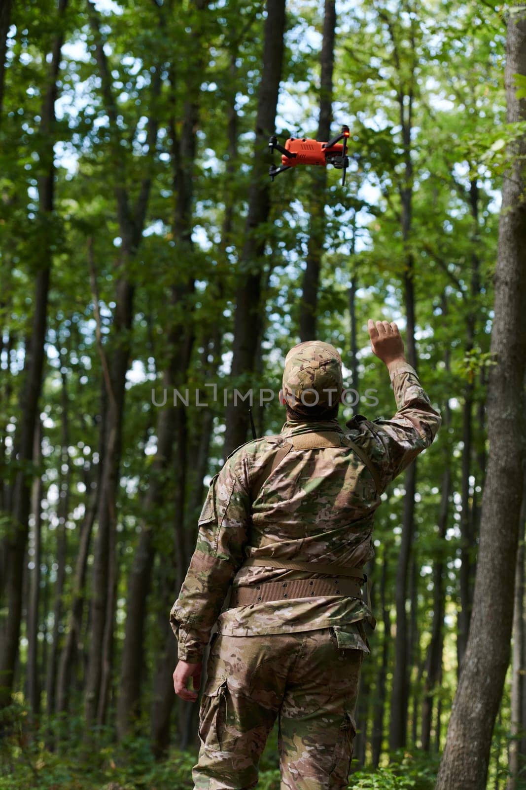 Elite military unit, equipped with state-of-the-art technology including a drone, strategically navigates and surveys dangerous wooded terrain, showcasing their precision, cooperation, and specialized training for high-risk operations by dotshock