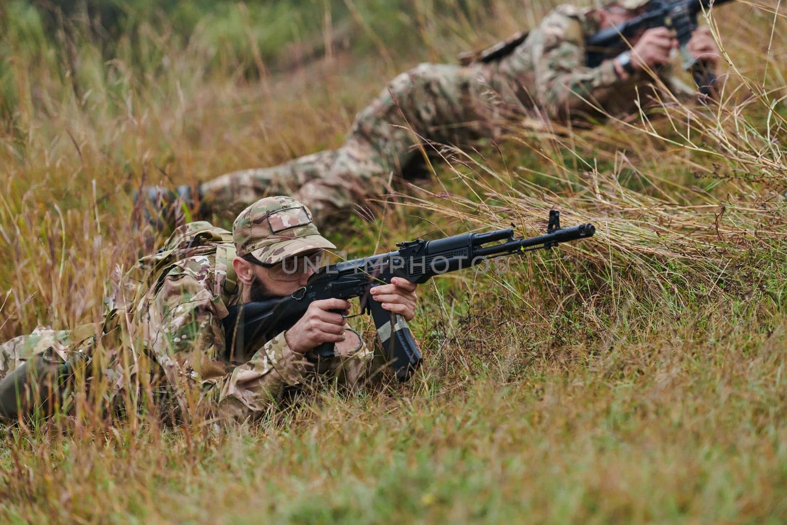 Elite soldiers stealthily maneuver through the dense forest, camouflaged in specialized gear, as they embark on a covert and strategic military mission by dotshock