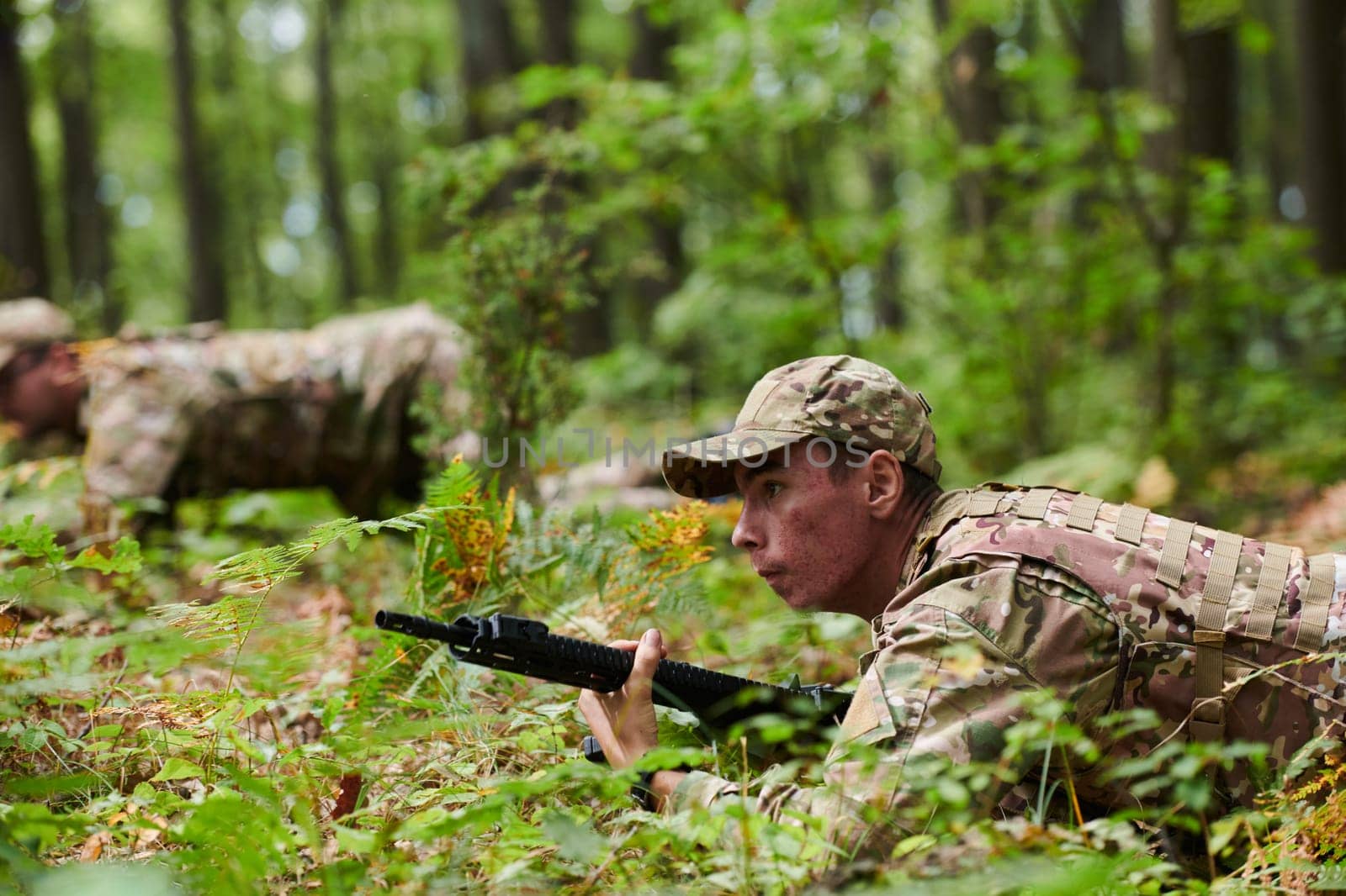 Elite soldiers stealthily maneuver through the dense forest, camouflaged in specialized gear, as they embark on a covert and strategic military mission.