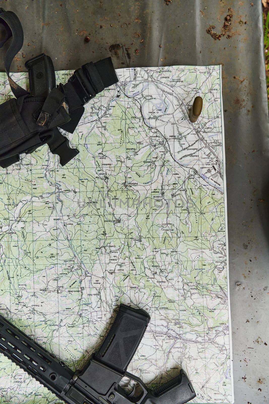 An array of military weapons, including rifles and pistols, is meticulously arranged on a table in a military base, presenting a close-up view of the diverse firepower and armament meticulously organized for readiness and strategic deployment by dotshock