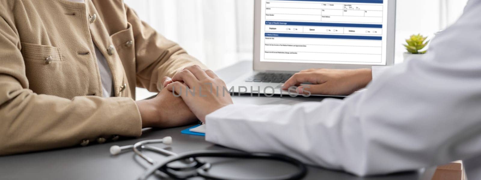 Doctor show medical diagnosis report and providing compassionate healthcare consultation while holding young patient hand for being supportive and professional in doctor clinic office. Neoteric