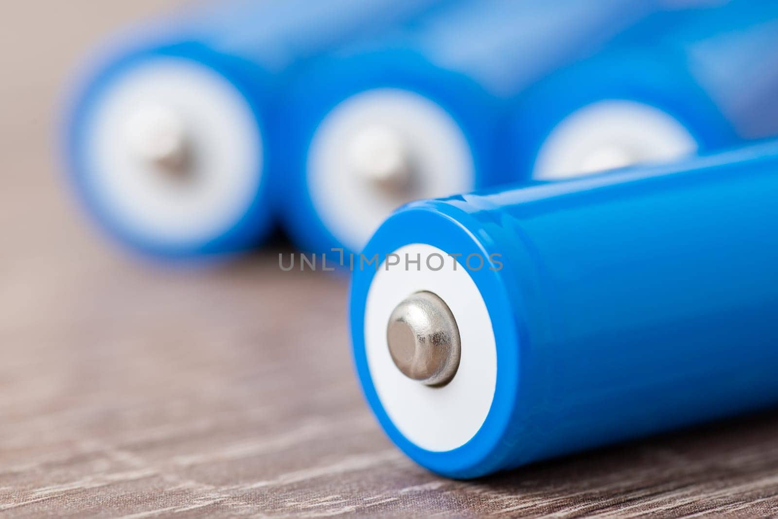 Close up of blue 18650 batteries on the table by VitaliiPetrushenko