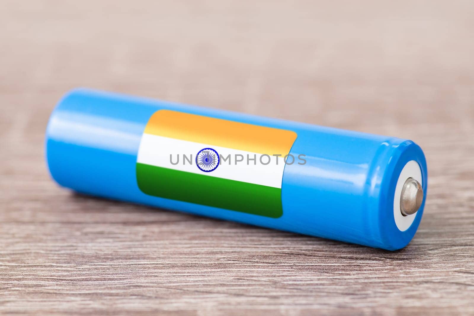 Rechargeable battery with flag of India on table by VitaliiPetrushenko