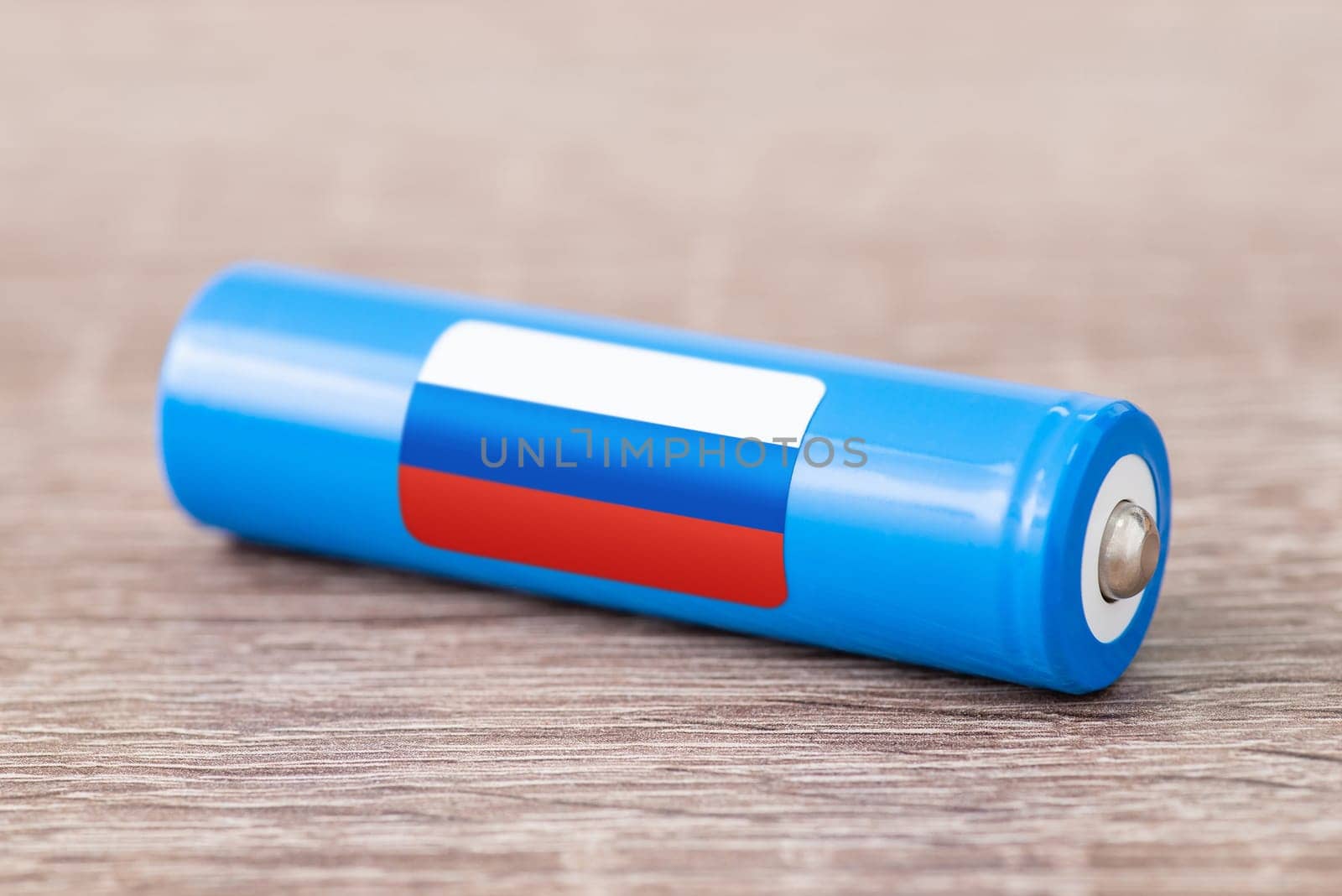 Rechargeable battery with flag of Russia on table by VitaliiPetrushenko