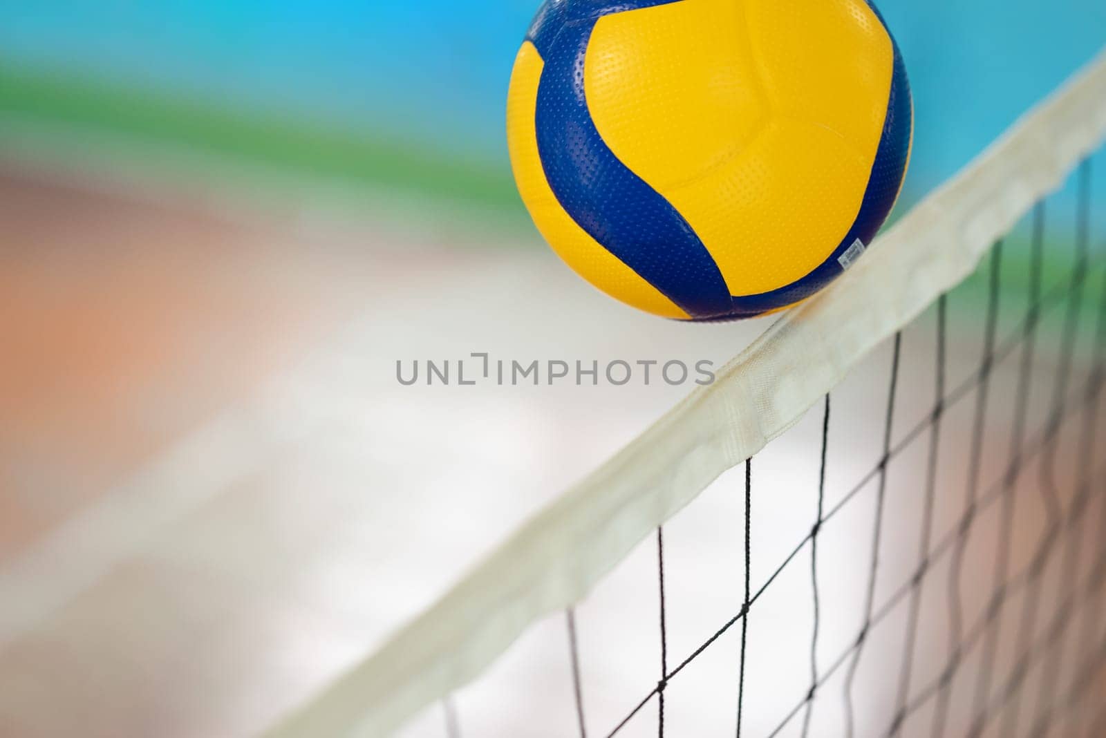 Close up of a ball over the net on volleyball court by VitaliiPetrushenko
