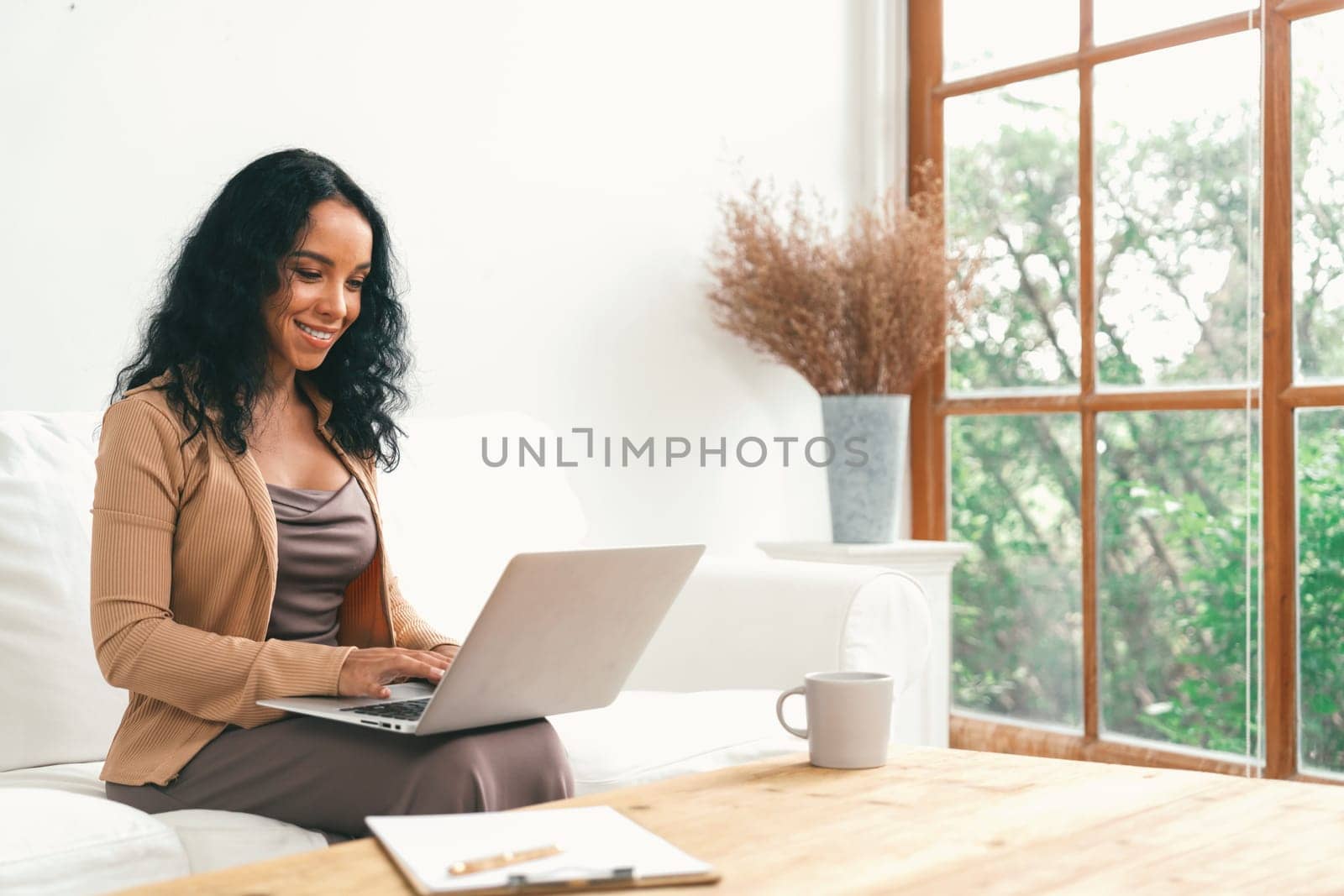 African-American woman using laptop computer for crucial work by biancoblue