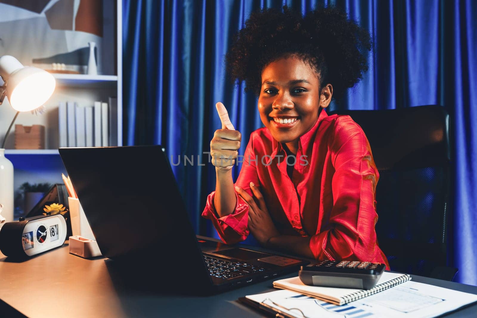 Working African woman with happy glowing, smiling face, getting new job project with good deal or marketing course scholarship information on laptop screen. Concept of cheerful expression. Tastemaker.